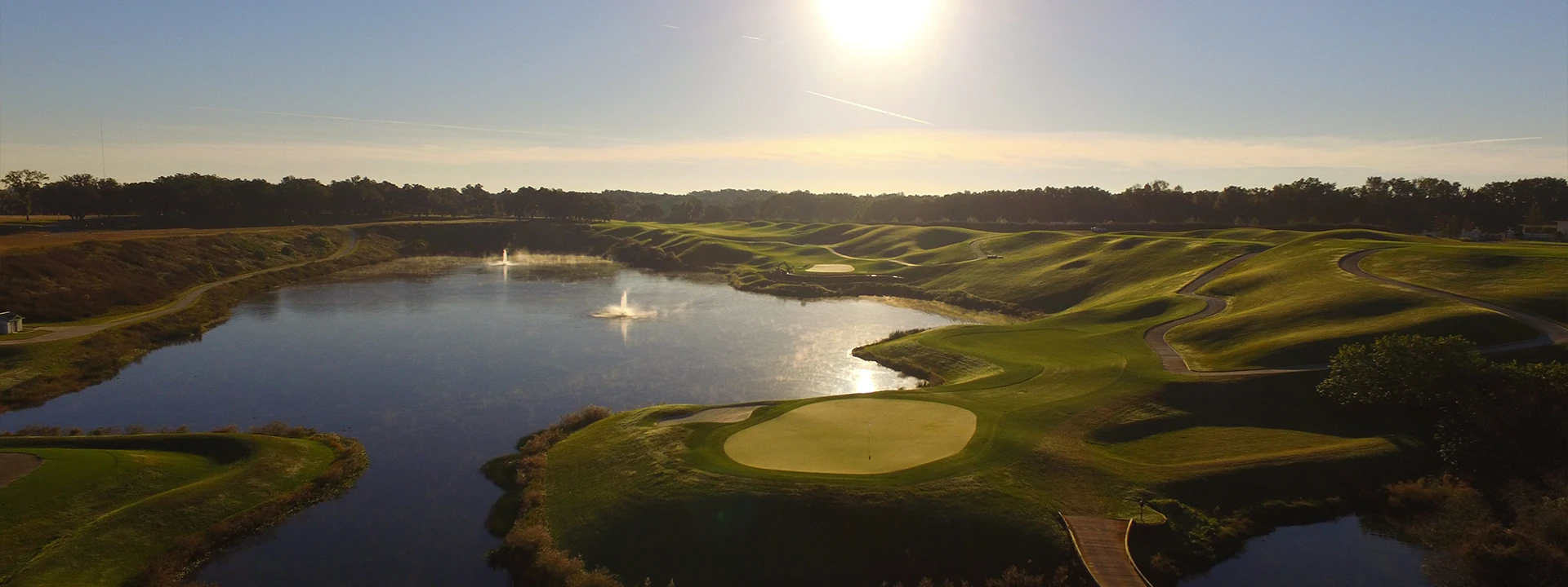 Aerial view of rolling golf fairways and greens surrounding Iron Lake in Ocala, Florida.