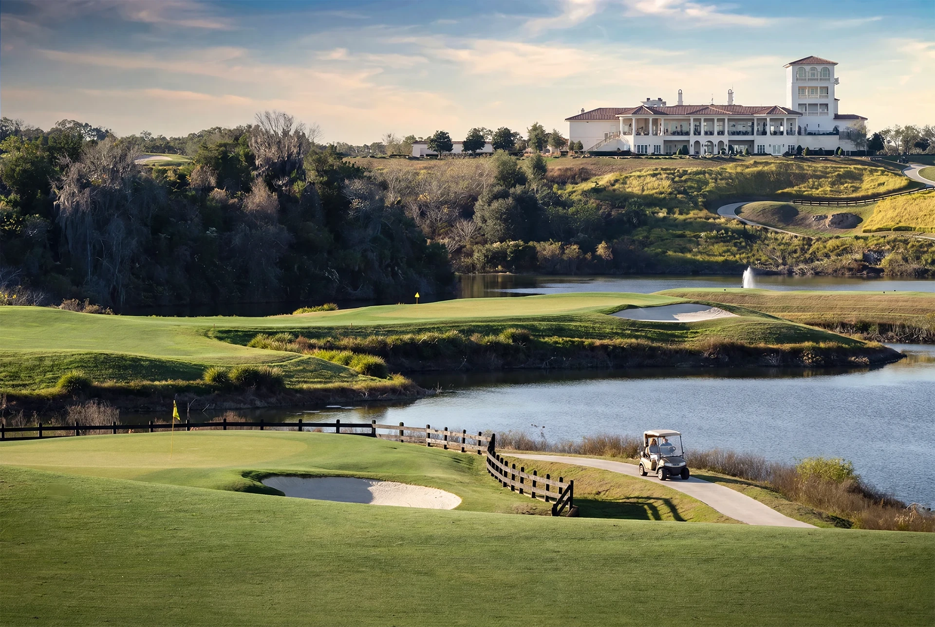 Panoramic view of the IronCrest golf course, quarry lakes, rolling terrain, and The Club at Iron Lake clubhouse in Ocala, Florida.