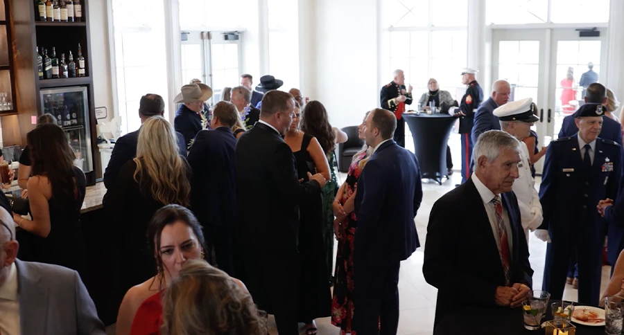 Members and guests gathering inside The Triple Bar at The Club at Iron Lake during a formal social event in Ocala, Florida.