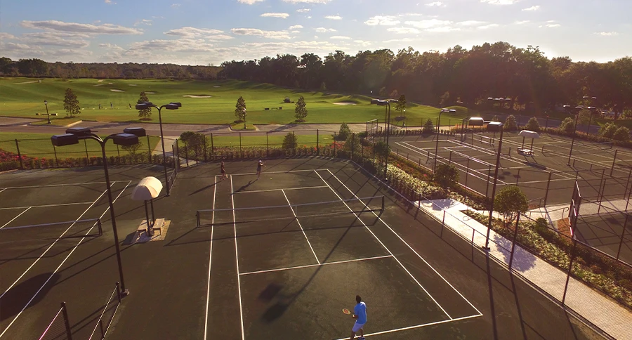 Players compete on tennis courts overlooking the golf course at The Club at Iron Lake in Ocala, Florida.